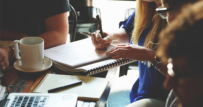 Group of people sitting around a table doing some group work