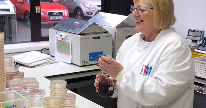 Service provider scientist holding a flask in a lab