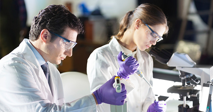 Male and female technician working in a lab.