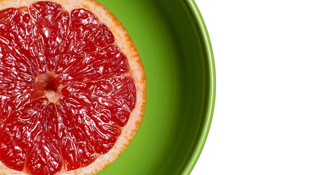 Large slice of orange on a bright green plate