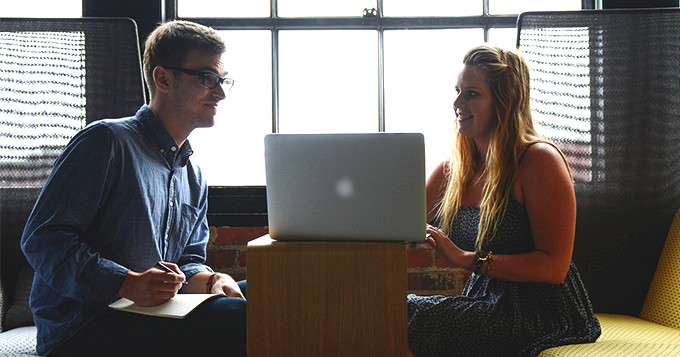 two colleagues having a meeting over a laptop