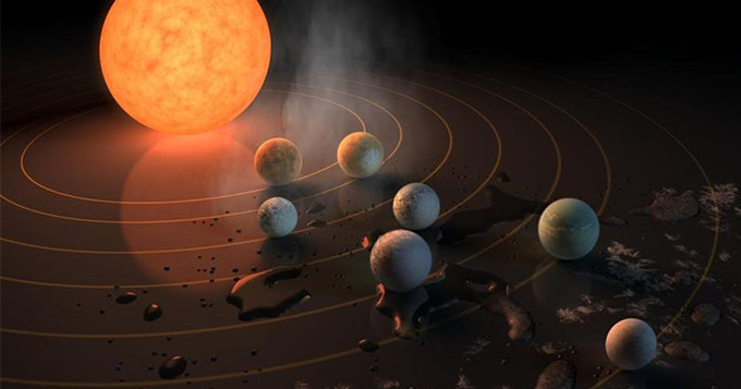 Artist concept drawing of TRAPPIST-1, a star with seven Earth-size planets orbiting it.