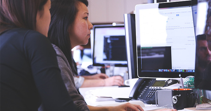 Colleagues working together at a computer