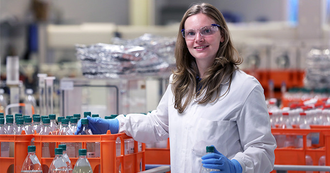 Anglian Water scientist Hayley in the lab with crates of bottled water samples