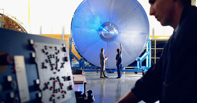 Developer scientist working on a large machine