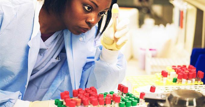 Explorer scientist examining the contents of test tubes