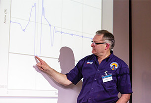 Ian Chartered Science Teacher delivers a presentation while pointing at a graph