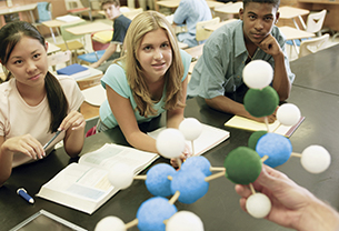 School students in a classroom learning about Chemistry