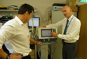 Paul RSci is showing a colleague how to use a medical equipment
