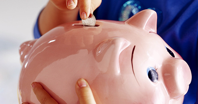 Photo of someone is holding a piggy bank