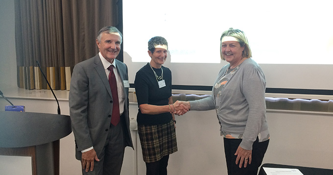 ASPiH is congratulated as a new member with a shake of hands