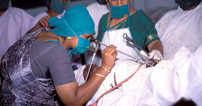 Doctor at hospital performing operation on woman. India. Image credit: John Isaac / World Bank.