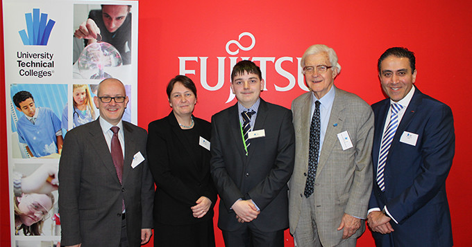 Panel speakers stand in front Fujitsu wall and UTC banner