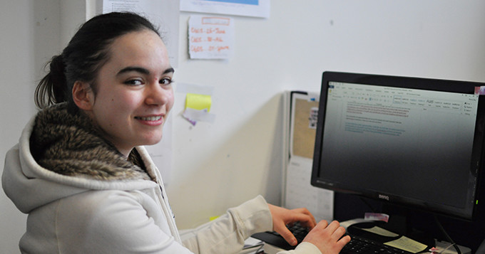 Science Council apprentice Kheira working on her computer at her desk