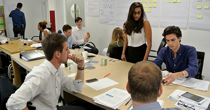 Group of graduates working as a team at a training event