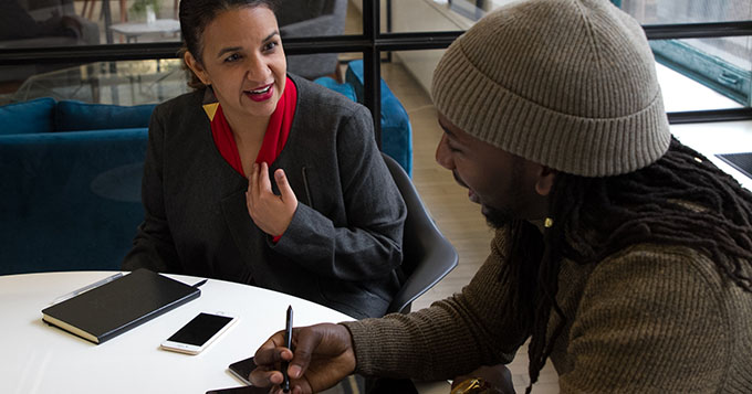 Two people having a discussion in an office