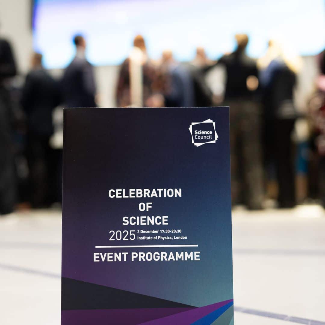 Table sign that reads 'Celebration of Science 2025, 2 December 17:30-20:30, Institute of Physics, London - Event programme'