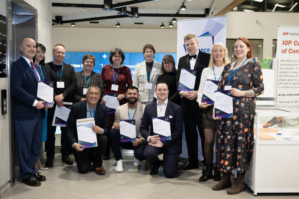 The winners of the Science Council Recognition Awards standing and kneeling in a group with Science Council CEO Della Freeth.